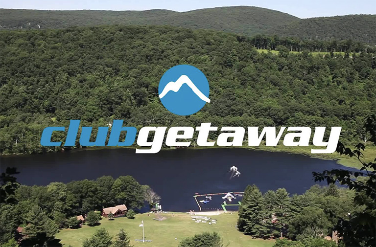 Aerial view of Club Getaways adventure camp lakeside property in Kent, Connecticut.